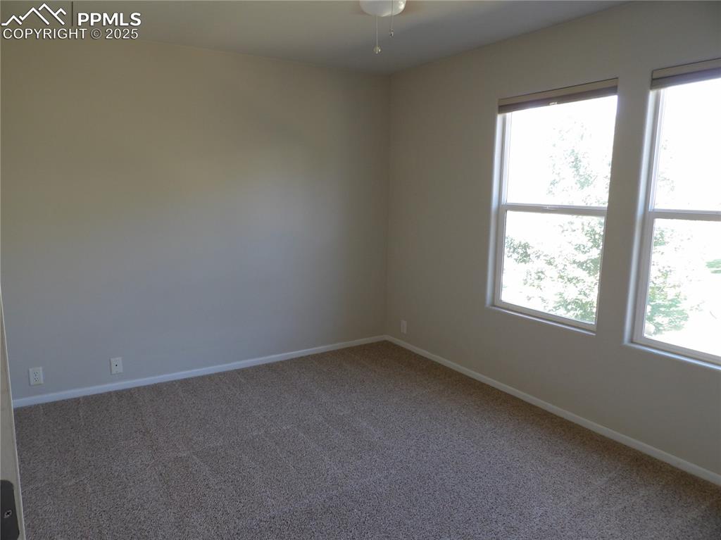 Empty room featuring carpet floors and baseboards