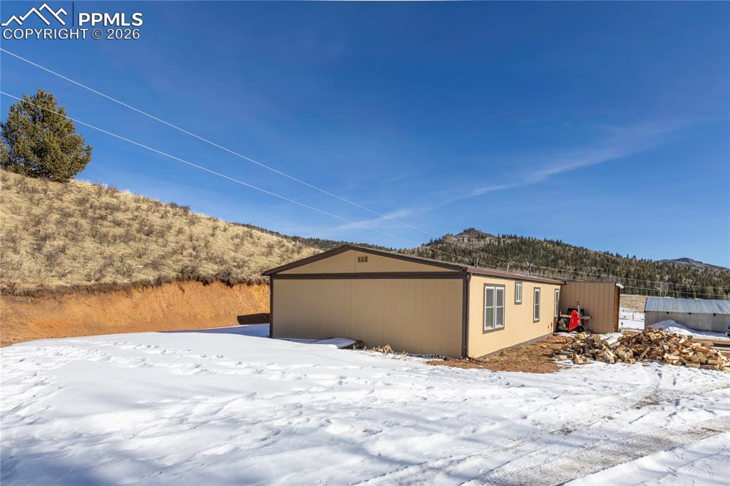 The side of the house and the surrounding hills!