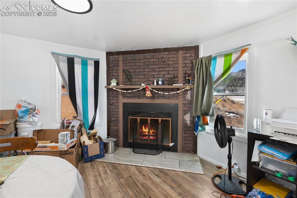 The dining area with wood finished floors and a wood fireplace!