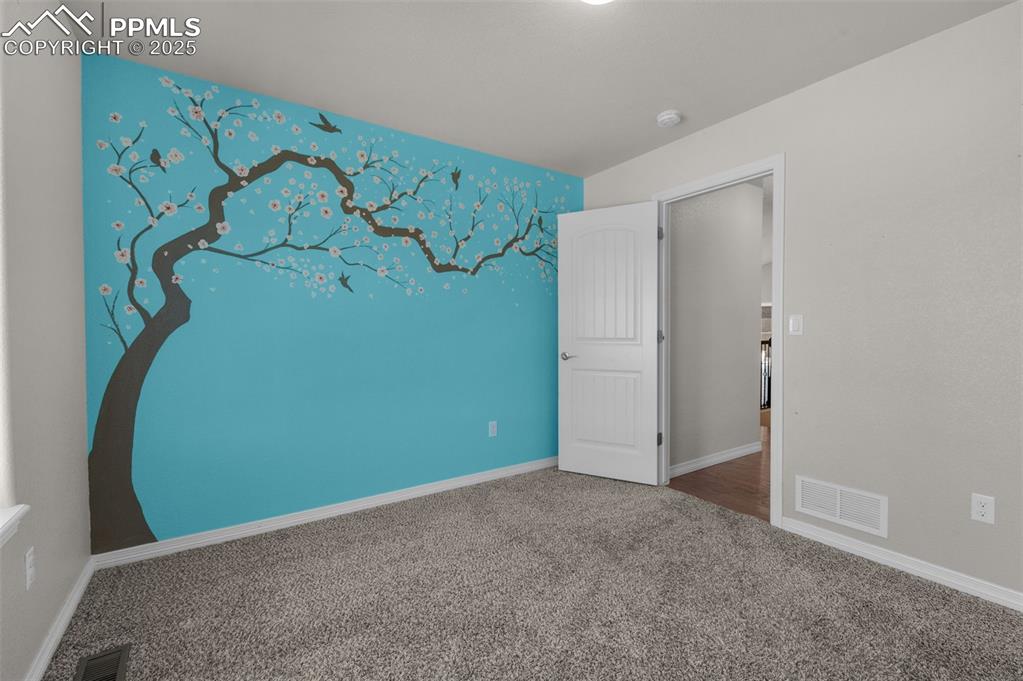 Secondary main level bedroom #2 with accent wall