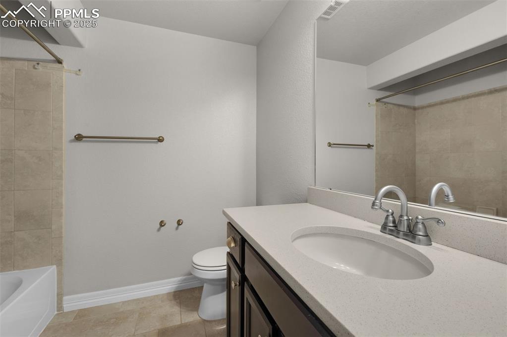 Full bathroom with vanity, shower / tub combination