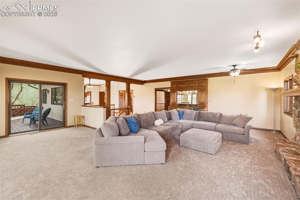 Open-concept design connects the living room to the dining area and upper deck, creating an ideal setting for entertaining or everyday living. Sliding glass doors enhance indoor-outdoor flow.