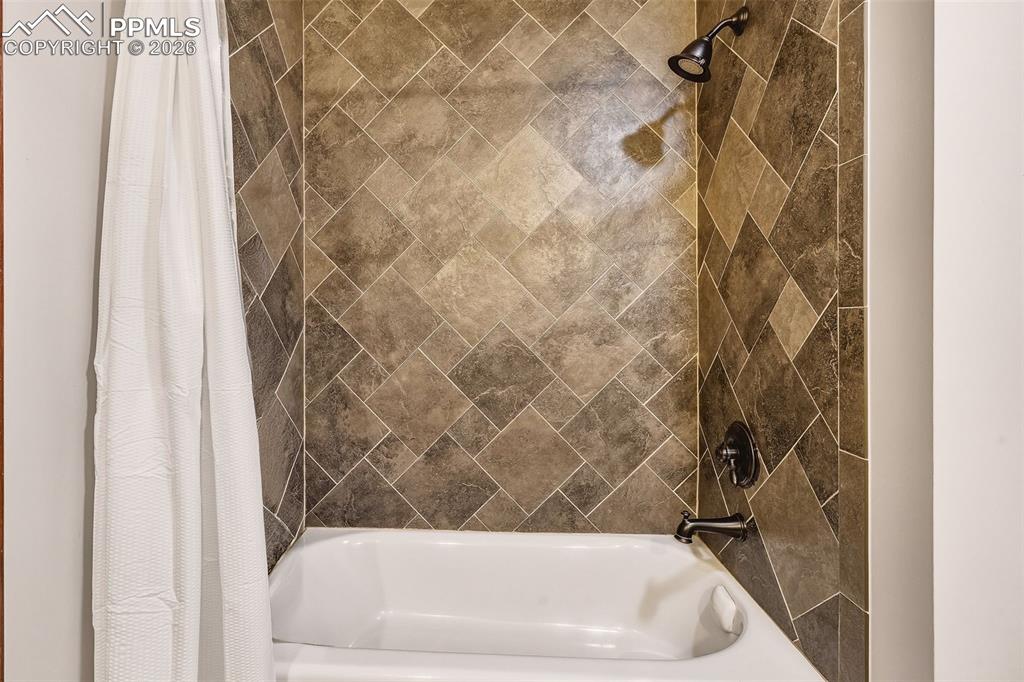 Updated bath #2 featuring tile-surround tub/shower combination with modern fixtures and durable finishes.