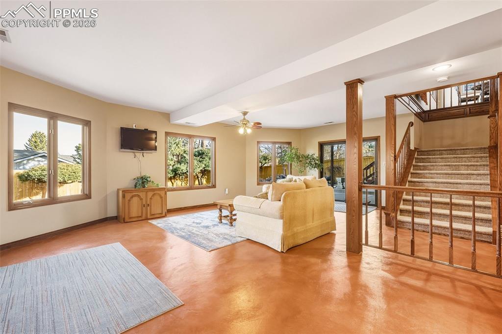 Basement Family Room – Open lower-level living area with refinished flooring, large windows, and walkout access to the patio, creating a comfortable secondary gathering space.