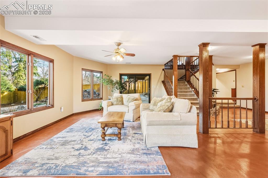 Basement Family Room – Reverse View – Expansive layout connecting the family room to the staircase and outdoor access, offering flexible space for recreation or relaxation.
