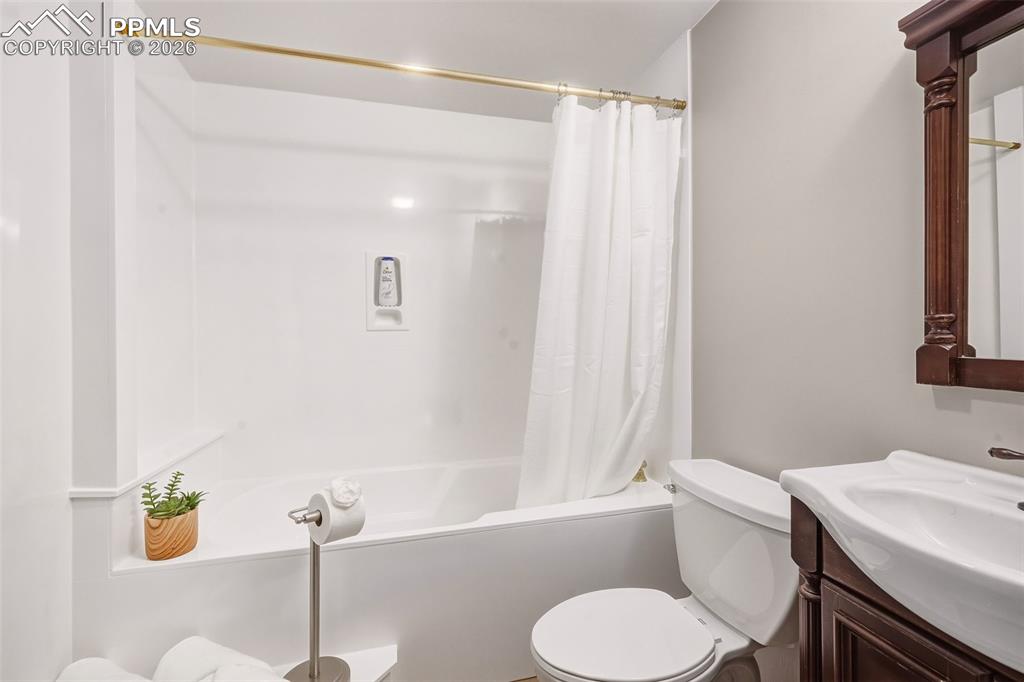 Clean and bright full bath featuring a tub/shower combination with durable surround and updated finishes for easy maintenance.