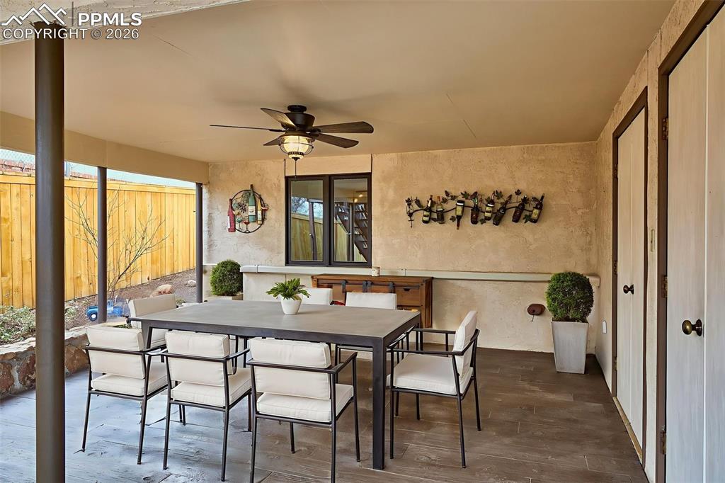 Covered Patio – Spacious covered patio with ceiling fan and upgraded stamped concrete flooring, creating a comfortable outdoor dining and lounging area with direct access to the backyard.