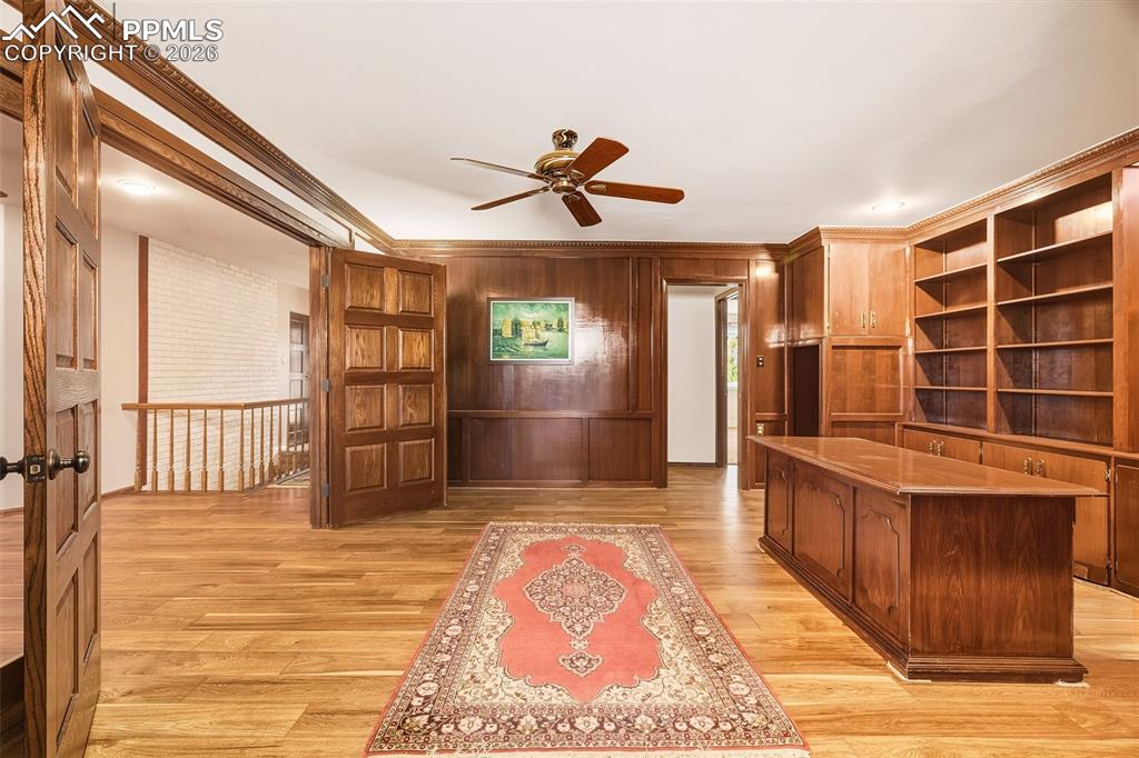 custom wood and hand craftsman finished study featuring extensive built-in shelving, cabinetry.  A rare and versatile room ideal for a library, office, or creative studio.