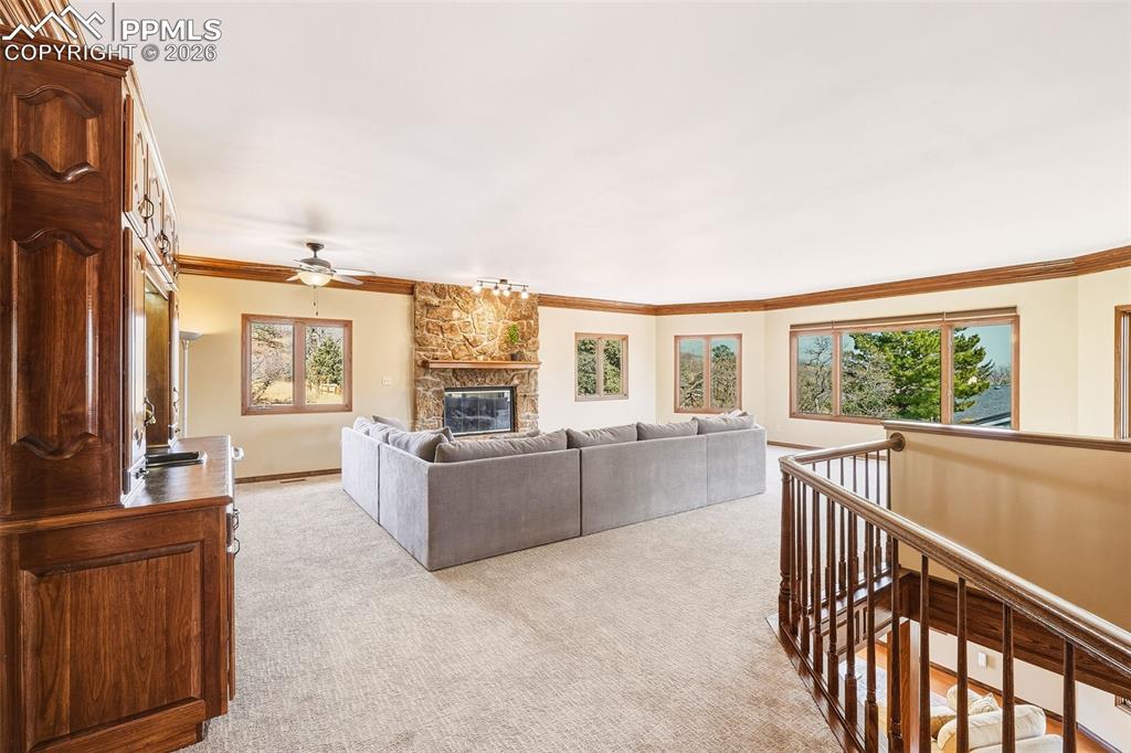 Elevated position with railing detail and expansive windows offers peaceful, tree-framed views and a bright, airy feel.