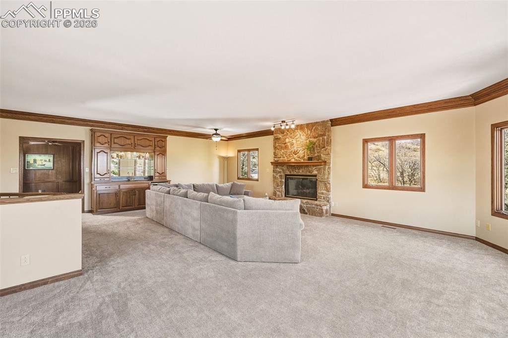 Generous gathering space with abundant natural light and warm wood trim details throughout. The updated gas fireplace adds comfort and ambiance for year-round enjoyment.
