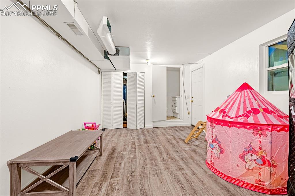 ADU Rec room with light wood-style flooring