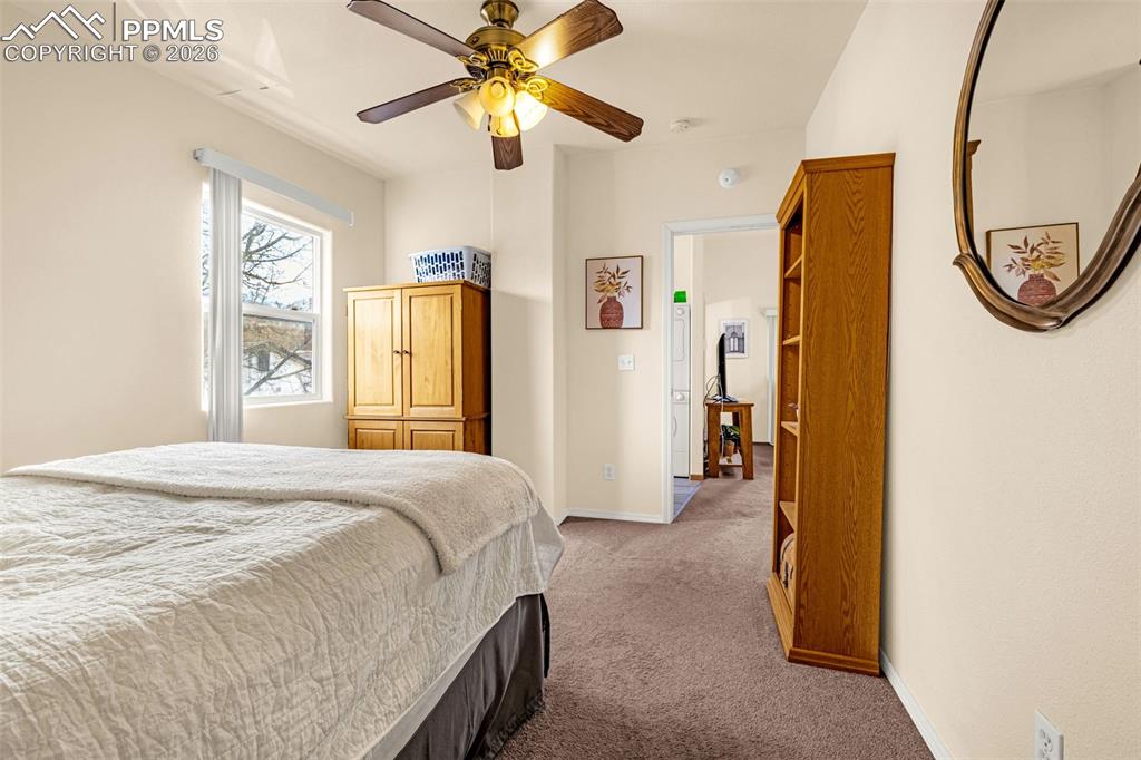 ADU Carpeted bedroom with ceiling fan and baseboards