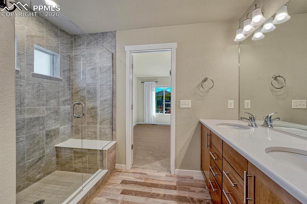Oversized tiled shower includes built-in bench