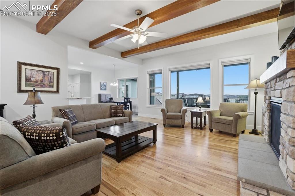 The great room has high, beamed ceilings and is open to the kitchen.