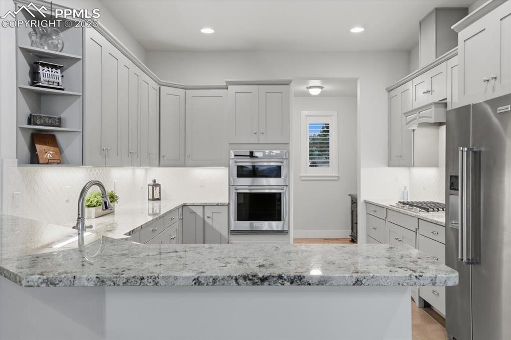 This spacious kitchen is centrally located in the home, with easy access to the garage entry for unloading from your grocery run, plus a double pantry and access to both the formal and informal dining areas. 