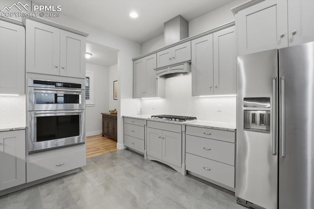 The upscale appliances include a gas cooktop with recessed vent hood, convection/microwave and a wall oven. 