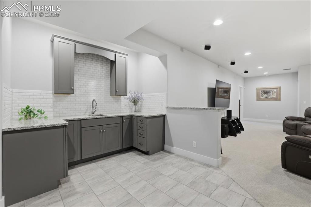 The basement wet bar is the perfect spot to grab a snack. 