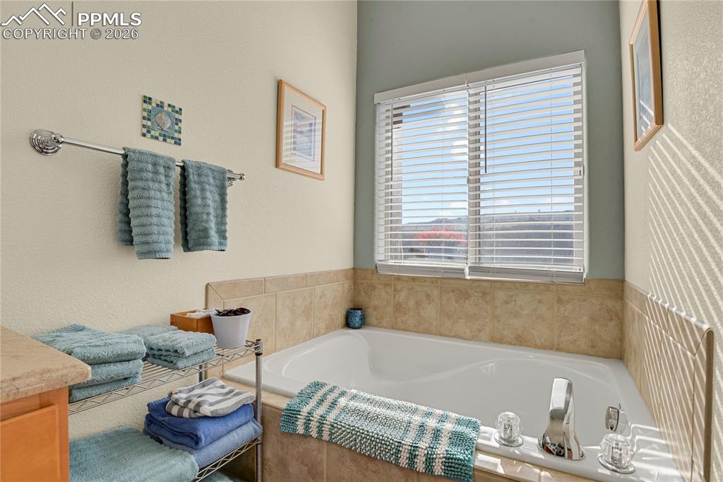 Large soaking tub in main level Primary bathroom.