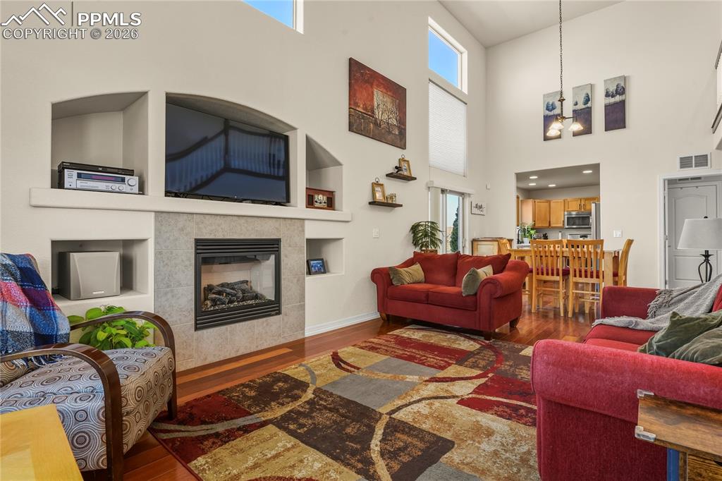 Large, main level family room featuring gas fireplace, Brazilian wood flooring & built ins. Tons of natural light!