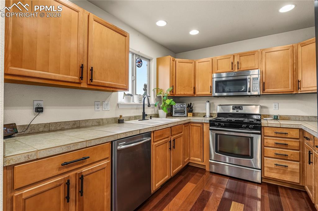 Ample cabinet and counter space. Stainless steel appliances, including refrigerator.
