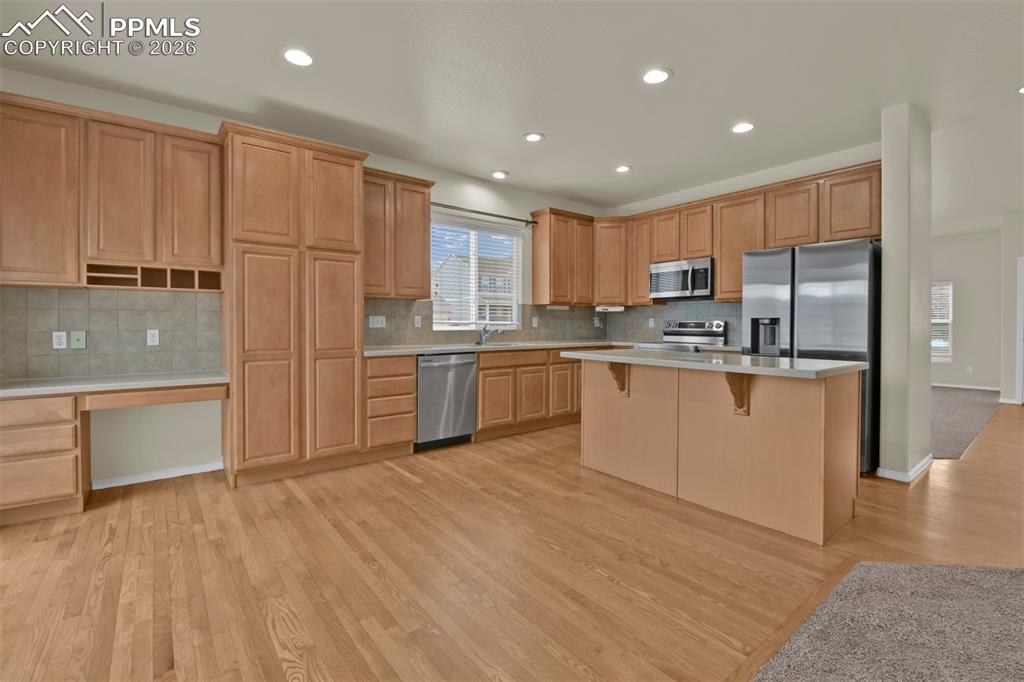 Spacious kitchen with island, and stainless steel appliances