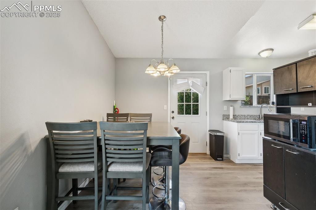 Dining room featuring a chandelier and light wood-style floors