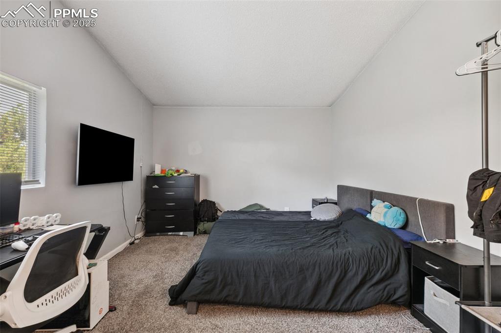 Bedroom with carpet and a desk