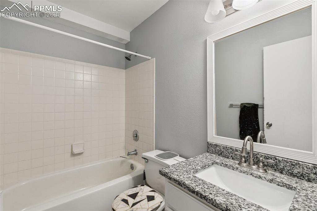 Bathroom with vanity and shower / bath combination