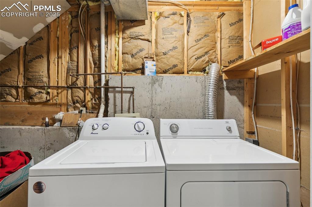 Laundry area featuring washing machine and clothes dryer
