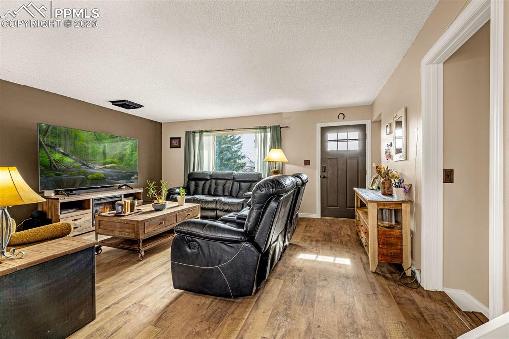 Living area featuring hardwood / wood-style flooring and a textured ceiling
