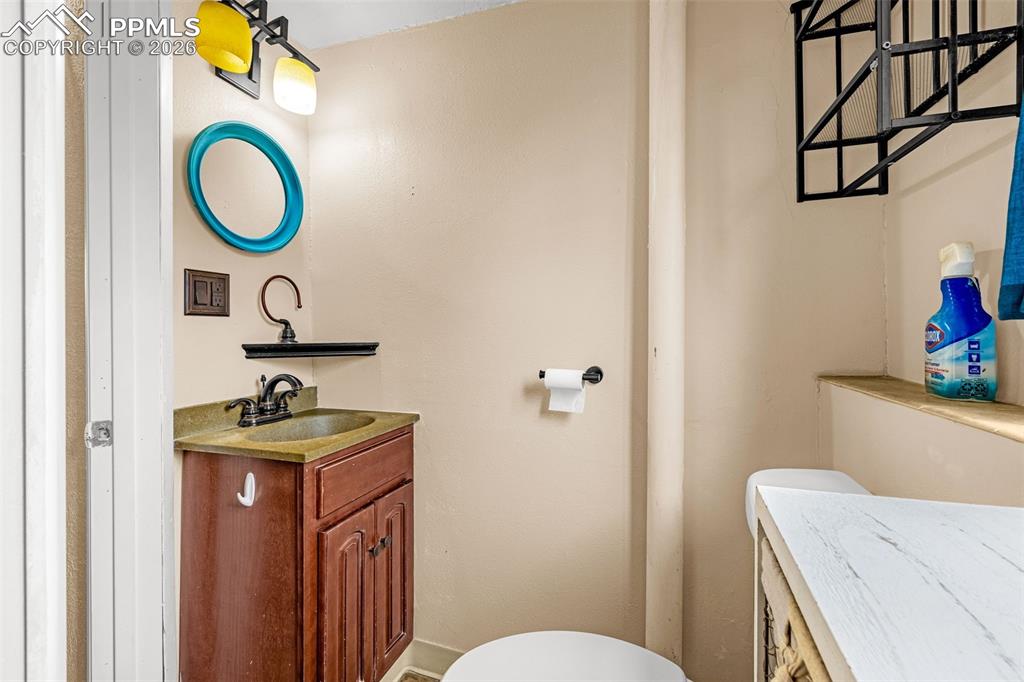 Half bathroom featuring toilet and vanity