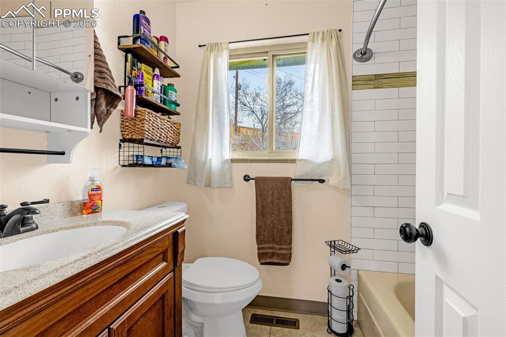 Bathroom featuring vanity and shower / bathtub combination