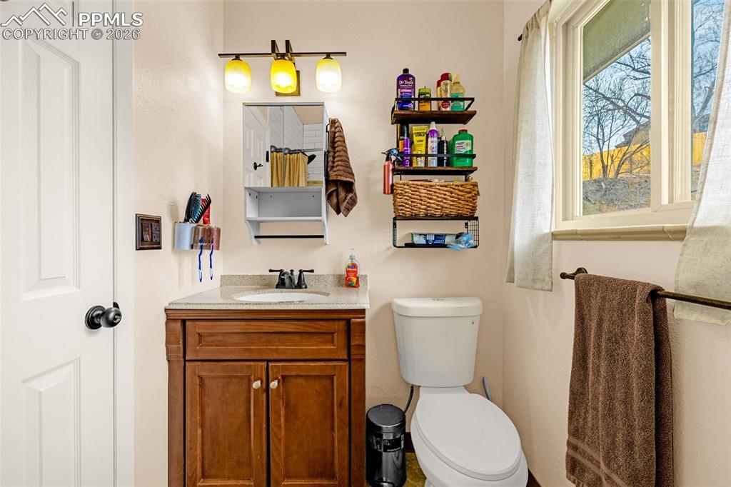 Half bath featuring vanity and toilet