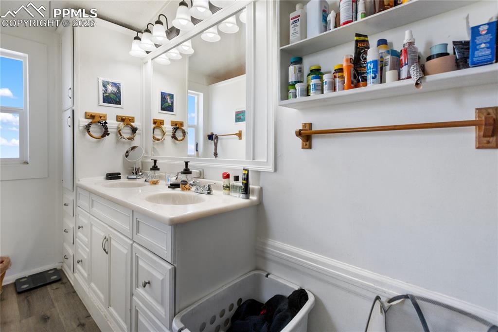 The bathroom with double vanity and wood floors!