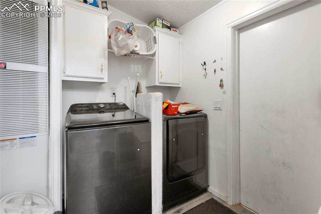 The laundry room has a washer and dryer, plus cabinet space!