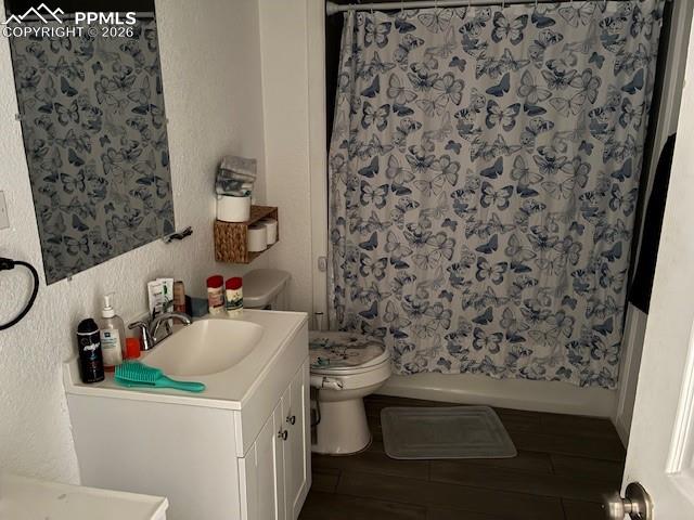 Bathroom with a textured wall and vanity