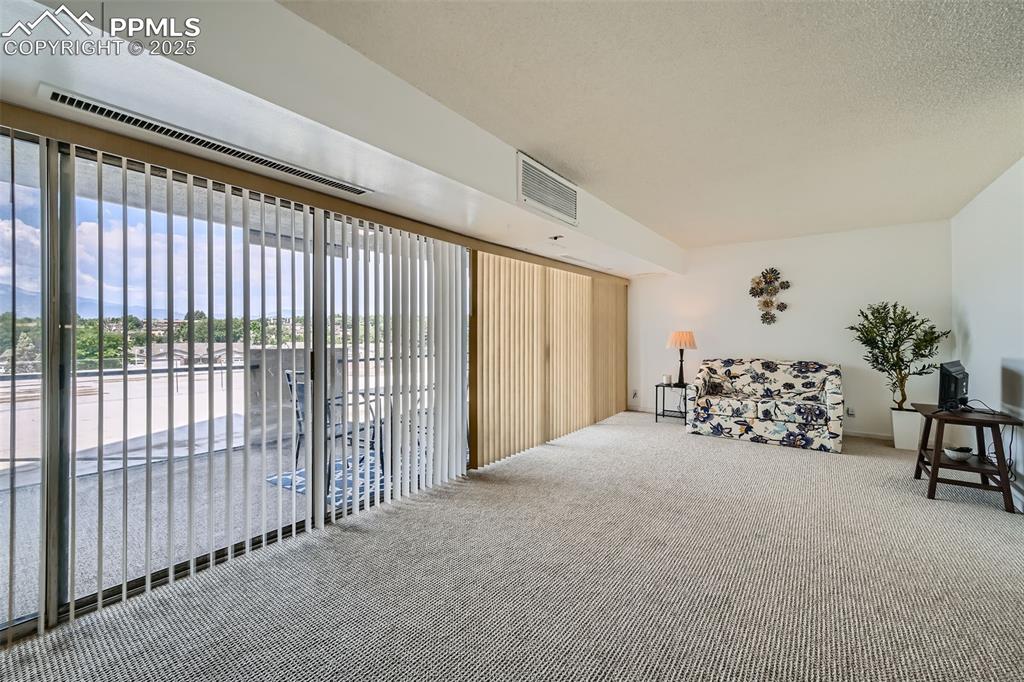 Sitting room featuring carpet floors