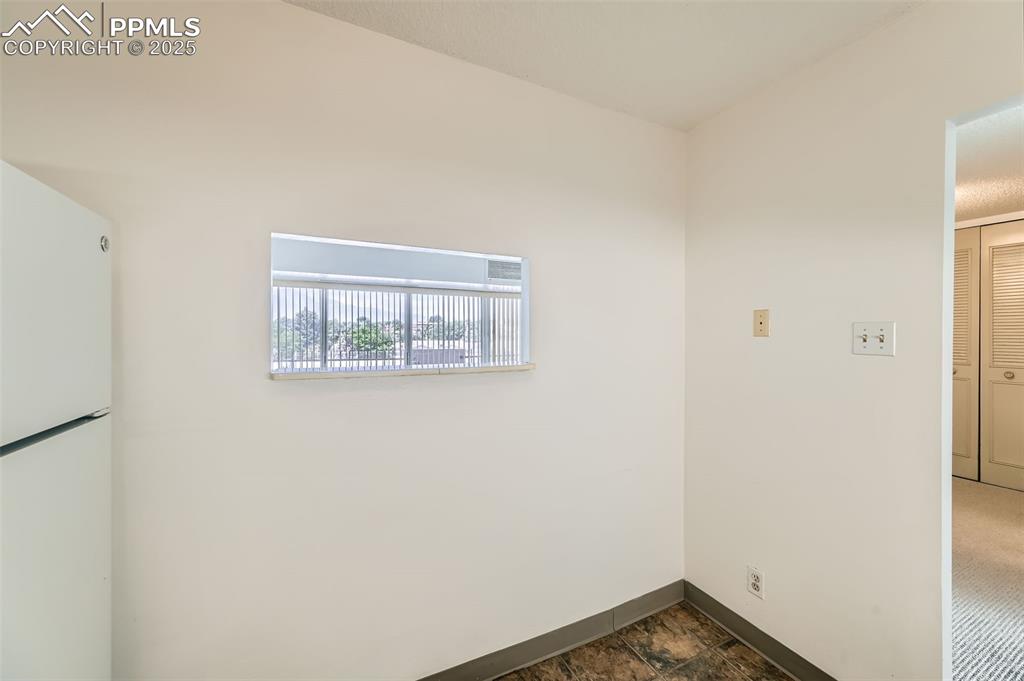 Empty room featuring baseboards