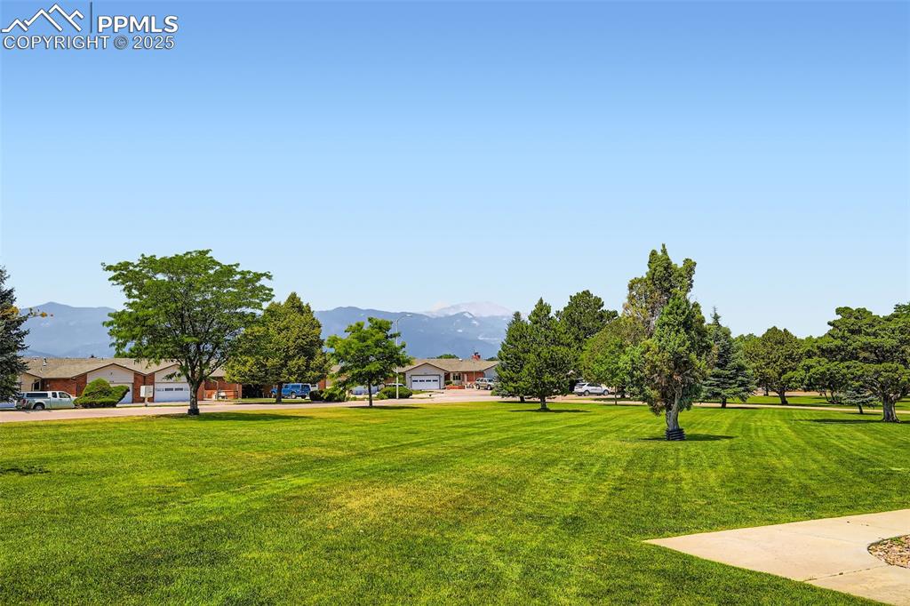 View of grassy yard featuring a mountain view