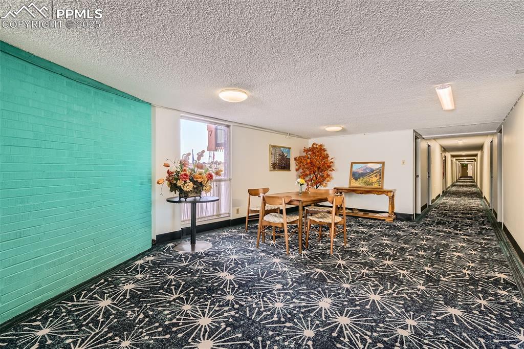 Dining area with baseboards and a textured ceiling