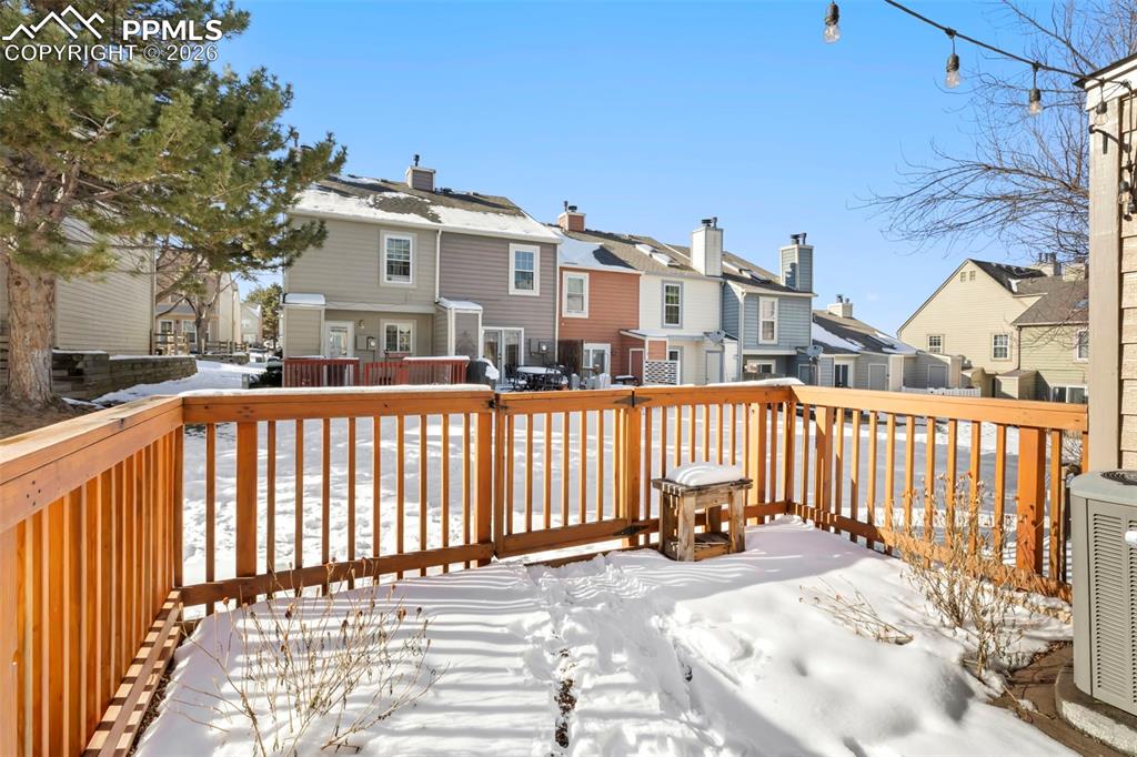 Snow covered deck with a view of community green area