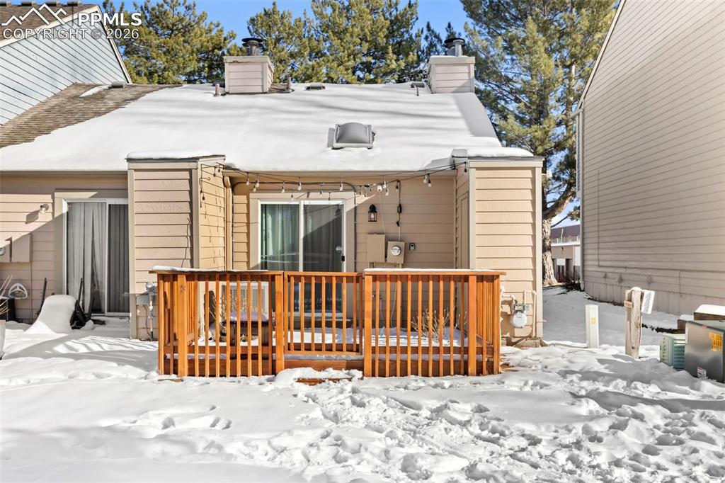 Back of property featuring a chimney and a fenced-in patio