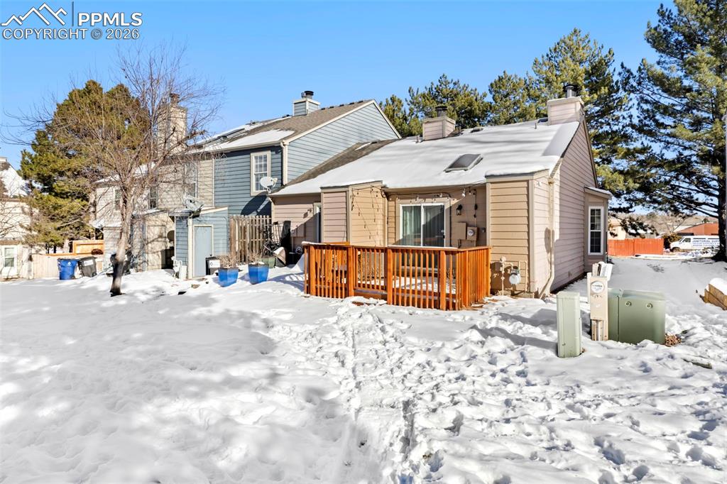 Rear of property with a fenced-in patio and a chimney