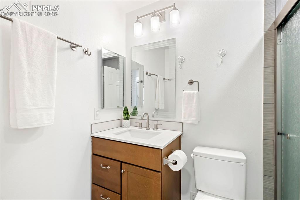 Full bath with vanity and an enclosed shower