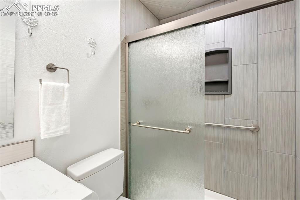 Full bathroom featuring a shower stall and vanity