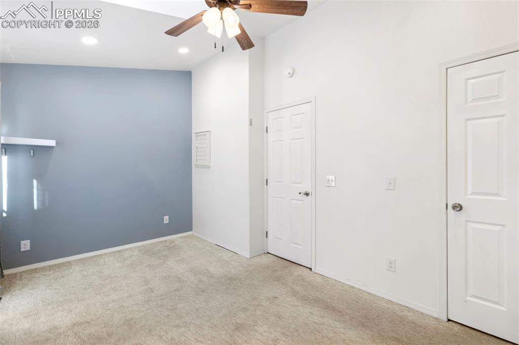 Bedroom featuring light colored carpet, ceiling fan, and recessed lighting