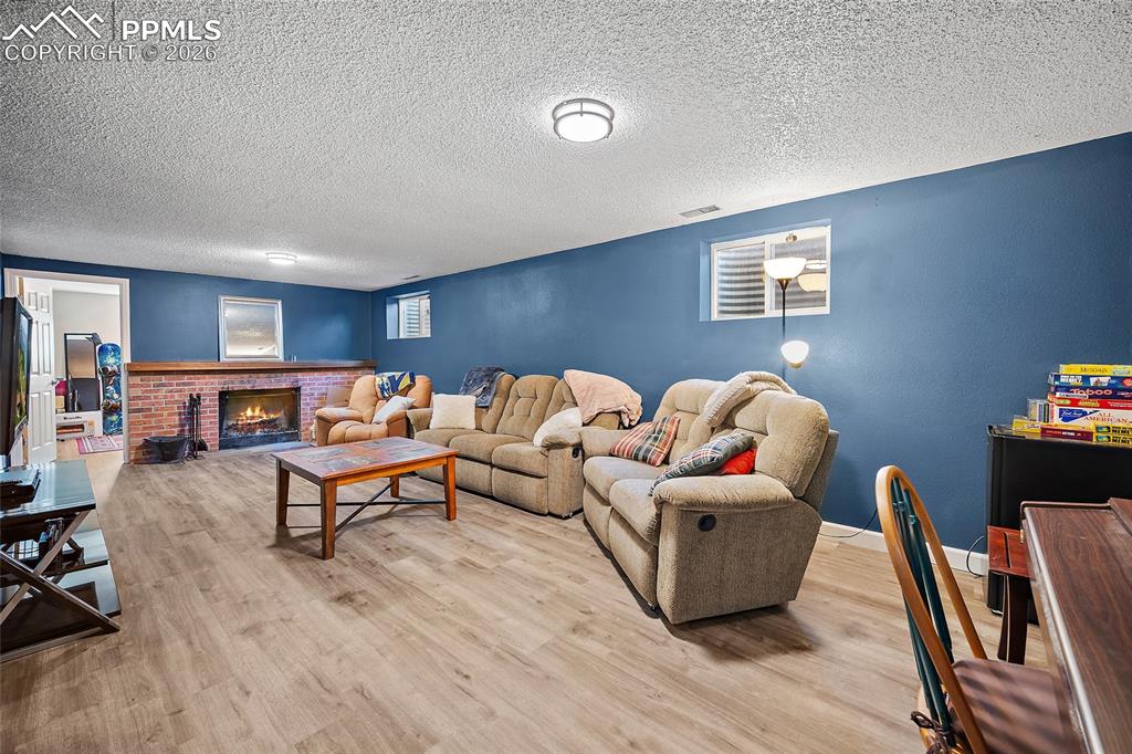Lower level family room with wood burning fireplace. 