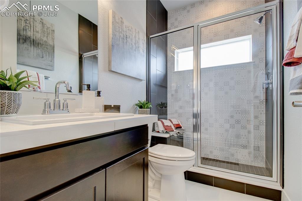 Bathroom featuring a stall shower and vanity