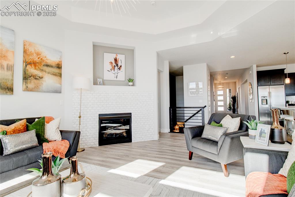 Living room featuring a fireplace, light wood-style floors, and recessed lighting