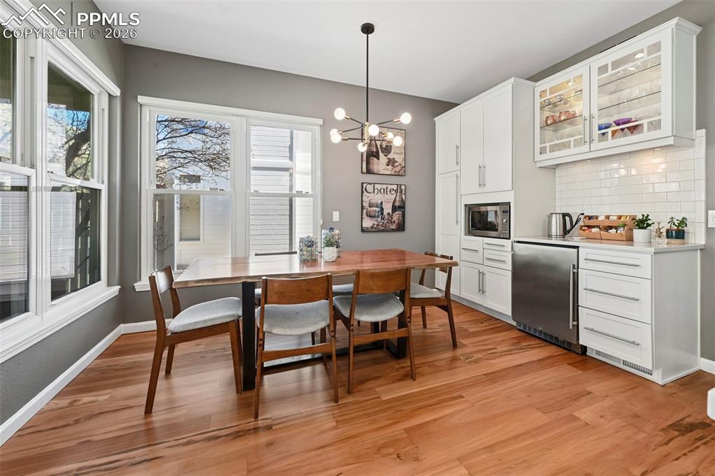 Dining area with a chandelier and wood flooring